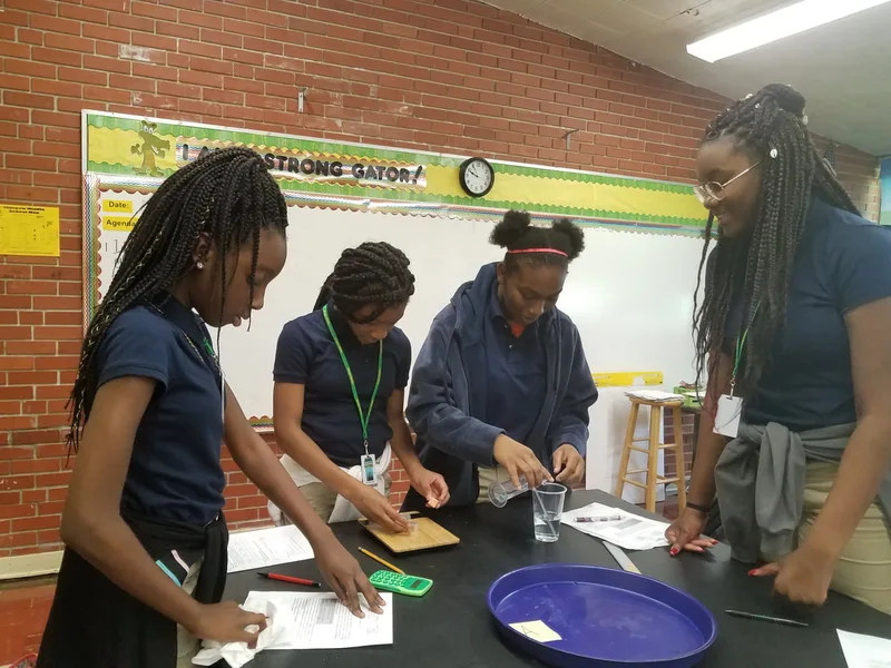 Photograph of four students working on a science experiment