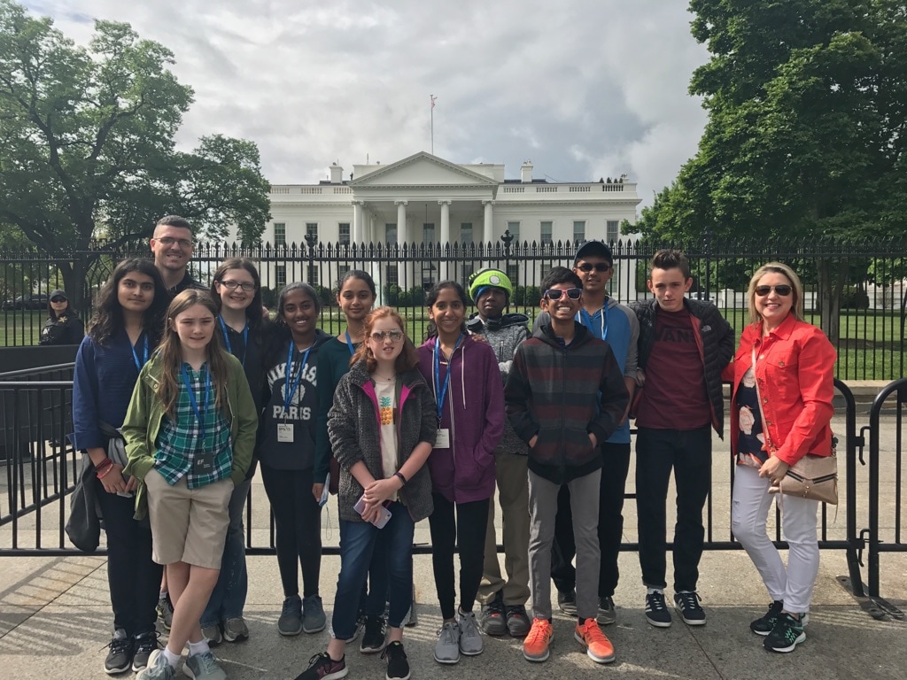 A group of students and adults standing in front of the White House